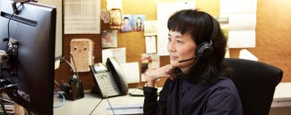 Woman working at desk on her computer
