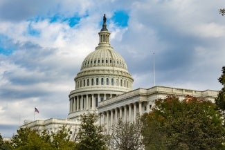 image of u.s. capitol dome with clouds in background