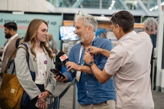 mike chapman interviews attendees expo floor