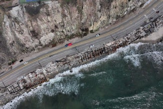 aerial view of malibu coastline with charred residential remains
