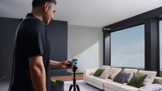 A laser distance meter in use indoors