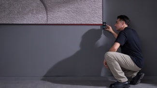 A worker measuring an item