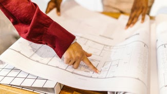 Women architects looking at plans