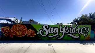 mural depicting flowers and san ysidro in cursive writing