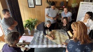 Architects around a table providing disaster assistance