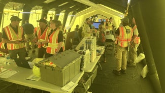 Architects around a table providing disaster assistance