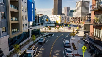 street view facing museum of play with multifamily residences on either side