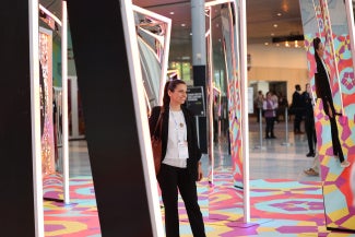 woman standing near AIA25 main entrance photo activation