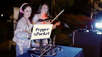 A DJ and violinist perform