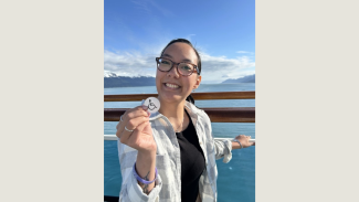 Rachel Wiesbrock holding the ISA symbol