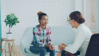 A young woman talking to a therapist