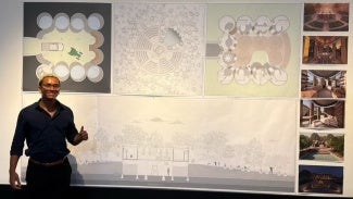 young man standing in front of architectural presentation