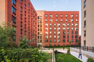 rendering of a red brick development with a walkway and green space