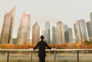 Woman starting at buildings