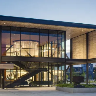 A warmly lit building exterior at dusk