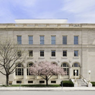 square white building with american flag to the right