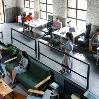 Wide Angle View of a Modern Loft Open Space Office With Businesspeople Working in It