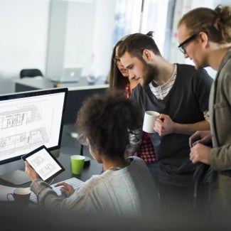 Group of colleagues working at a computer