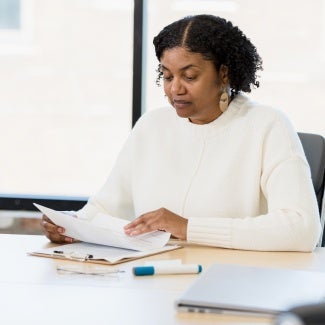 Female manager analyzes documents during meeting