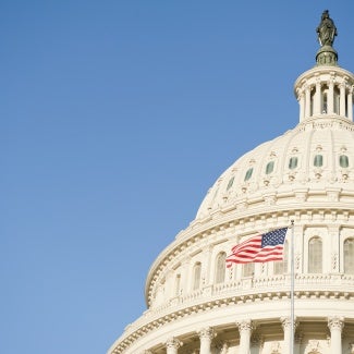 American flag waving in front of Capitol Hill 