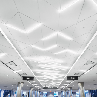 Three overlapping tiers of acoustical ceilings dominate the space with the eye-catching central corridor being the highest tier and the holding/gate areas the lowest.
