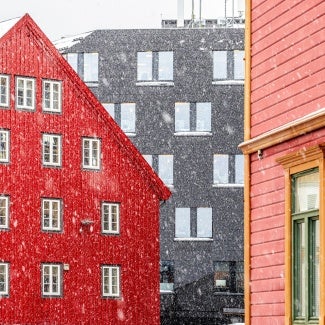 Buildings with falling snow indicating cold weather