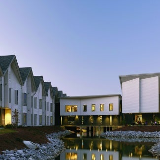 Residential buildings surrounding a small lake/creek