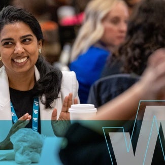 Woman smiling at conference event.