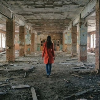 Lady in a destroyed and hazardous building