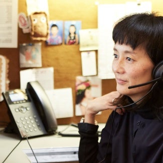 Woman working at desk on her computer