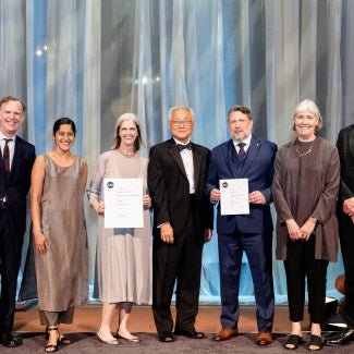 Group of award winners standing together on stage