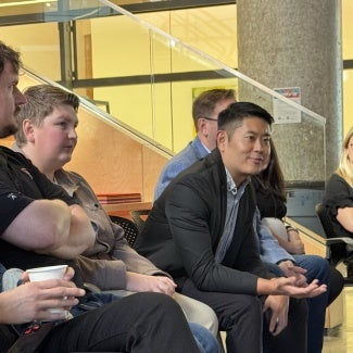 Members sitting in chairs discussing a project