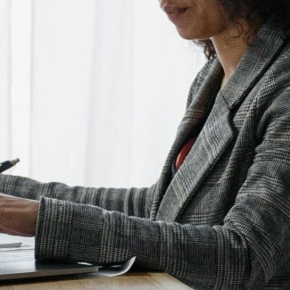 Woman working at desk on her computer