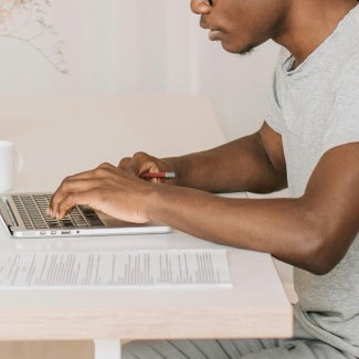 Man working on laptop at table