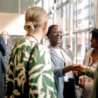 group of racially diverse people meeting and shaking hands at a networking event