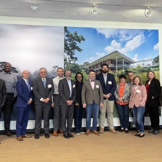 group of people in front of mural