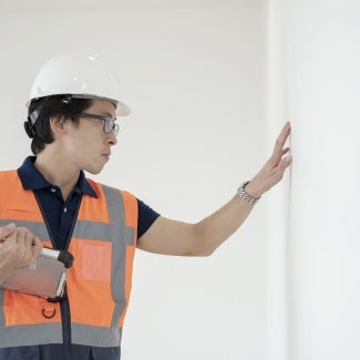 architect inspecting wall building envelope assessment