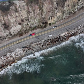 aerial view of malibu coastline with charred residential remains