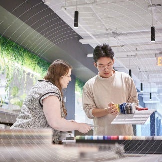 Two architects working together with a model