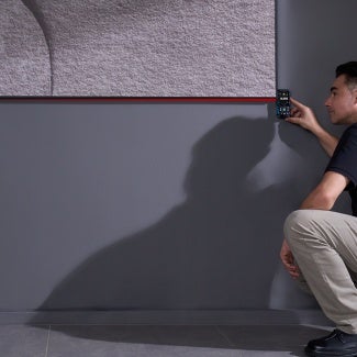 A worker measuring an item