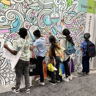Children decorate a mural