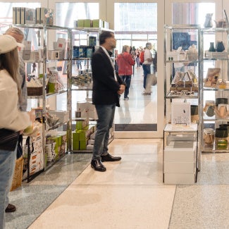 Customers browsing and shopping for products at the AIA Design Shop.