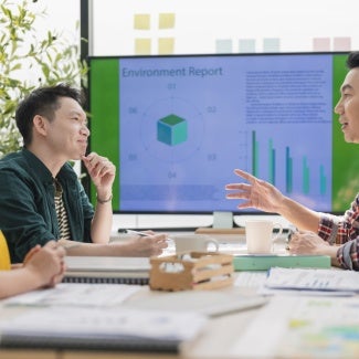 Three coworkers discuss a report