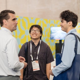 Attendees speaking to their mentor at conference