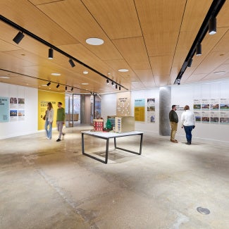 Museum attendees looking at architecture exhibit