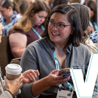 Women's Leadership Summit attendees smiling and drinking coffee