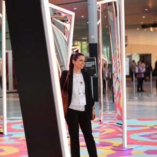 woman standing near AIA25 main entrance photo activation