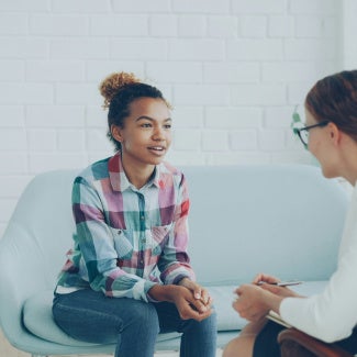 A young woman talking to a therapist