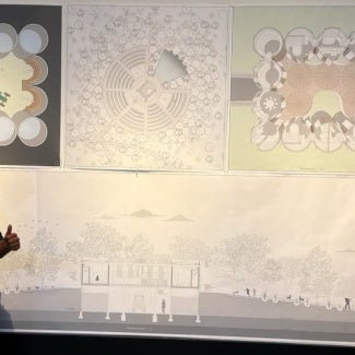 young man standing in front of architectural presentation
