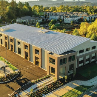 pre-engineered metal building in forested mountain landscape